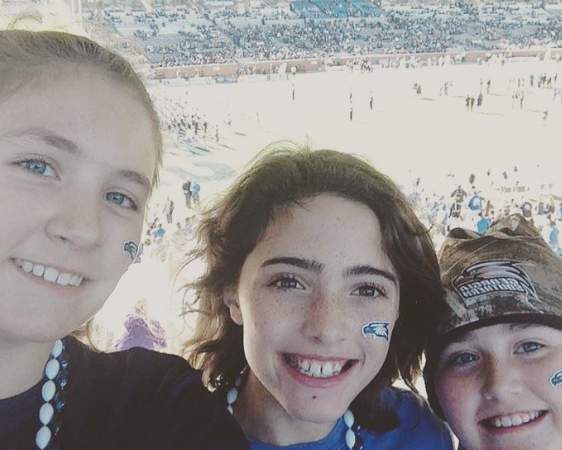 A childhood picture of Ansley, her sister and her brother cheering for Georgia Southern Eagles. 